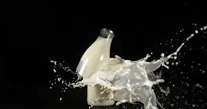 Black Background Photography Prints: Bottle of Milk Exploding against Black Background