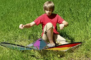 Handicrafts For Kids Prints: Boy assembles a stunt kite