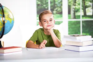 Single Person Studying Prints: Boy with books at a table