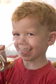 Happy Child Portrait Photo Prints: Boy drinks out of a glas