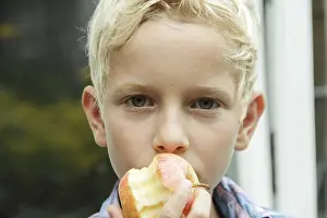 Apple Health Benefits Prints: Boy eating an apple