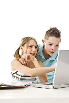 Teenage Education Prints: Boy and girl learning together with a computer