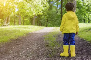 Caucasian Ethnicity Children Prints: The boy on the path in the Park stands with his back to the camera