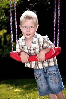 Young Boy Playing Outdoors Prints: Boy playing on the playground