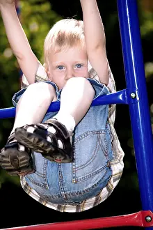Boy Looking At The Camera Prints: Boy playing on the playground