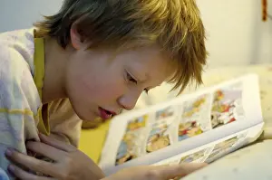 Boy Reading In Bed Prints: Boy reading in bed