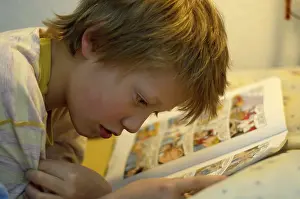 Boy Reading In Bed Prints: Boy reading in bed