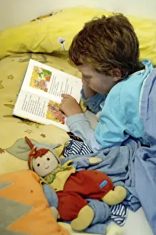 Boy Reading In Bed Prints: Boy reading in bed
