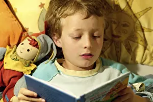 Childhood Leisure Activities Prints: Boy reading in bed