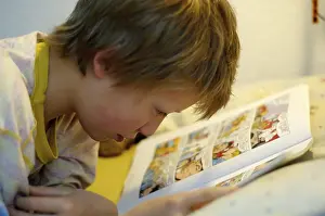 Boy Reading In Bed Prints: Boy reading in bed