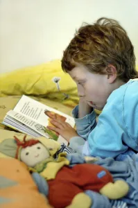Boy Reading In Bed Prints: Boy reading in bed