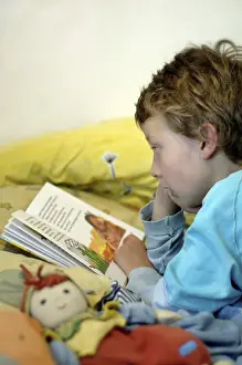 Boy Reading In Bed Prints: Boy reading in bed
