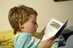 Boy Reading In Bed Prints: Boy reading in bed