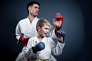 Martial Art Practice Prints: Boy with his trainer in a karate pose