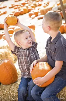 Pumpkin Patch Kids Prints: Two boys at the pumpkin patch talking about their pumpkins and having fun on a fall day