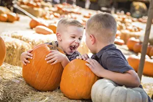 Pumpkin Patch Kids Prints: Two boys at the pumpkin patch talking about their pumpkins and having fun on a fall day