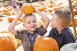 Pumpkin Patch Kids Prints: Two boys at the pumpkin patch talking about their pumpkins and having fun on a fall day