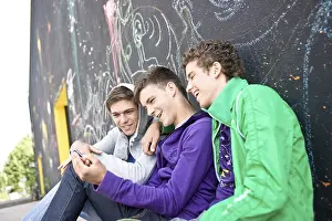 Casual Clothing Prints: Three boys sitting with their backs against a wall