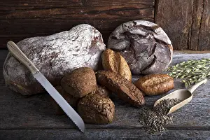 Rustic Wooden Surface Prints: Bread loaves, rolls and a bread knife