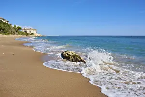 Tarragona Coastline Prints: Breaking waves on a sandy beach with a rock