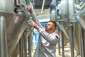 Industrial Building Architecture Design Prints: Brewery worker performing quality control