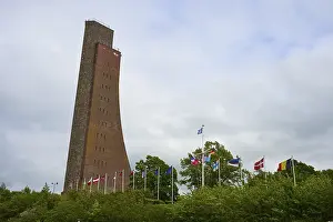 Laboe Naval Memorial Prints: Brick tower with flags surrounded by vegetation