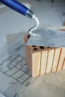 Construction Tool Prints: Brick trowl and brick on a construction plan