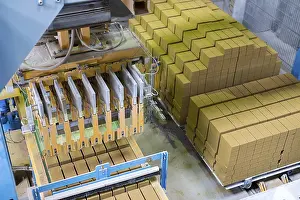 Industrial Building Interior Prints: Brickyard. Top view of machine and stacked bricks in workshop