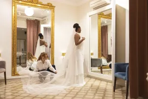 White Wedding Attire Prints: Bride stands elegantly in a fitting room