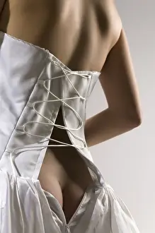 Celebrating Love And Togetherness Prints: The bride has unbuttoned a corset and bare back