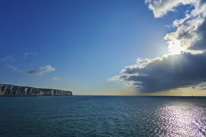 English Channel Coastline Prints: Brilliant sunlight through clouds over ocean and cliffs