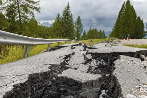 Deserted Mountain Roads Prints: Broken road with cracks in the road surface