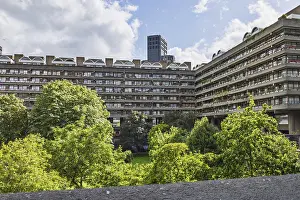 Prints of Brutalist Barbican Estate in London's City. Concrete terraces, lush courtyard and skyline beneath bright clouds Brutalist Architecture Prints: Brutalist Barbican Estate London City Print