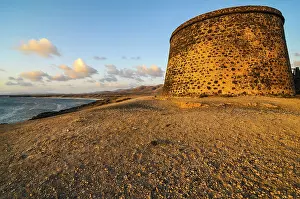 Cloudy Sky With Setting Sun Prints: Bunker at sunset on a cloudy sky