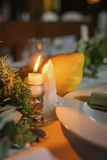 Candlelit Dinner Scene Prints: A burning candle next to a lemon on a festive table