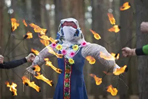 Prints of Burning straw stuffed carnival, a symbol of winter and death in Slavic mythology, pagan tradition. Religious and folk festival of the East Slavic people Belarus Prints: Burning Straw Doll Print: Slavic Winter Symbol