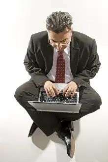 Business Professional Photo Prints: Businessman with a notebook on his lap