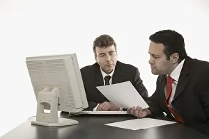 Business Professionals Meeting Prints: Two businessmen going over documents