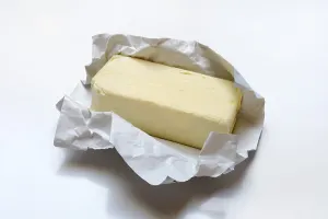 Single Coloured Background Photos Prints: Butter with opened packaging