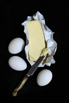 Plain Colored Background Eggs Prints: Butter in opened packaging and eggs