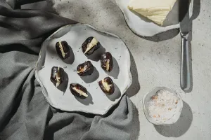 Rustic Ceramic Plate Prints: Butter stuffed dates are elegantly presented on a rustic ceramic plate
