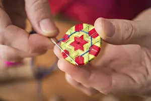 Regional Handicrafts Prints: Button maker stitching and wrapping green
