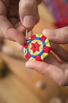 Regional Handicrafts Prints: Button maker stitching and wrapping green