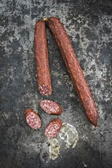 Foodstuff Cuisine Images Prints: Cabanossi sausages on rustic table