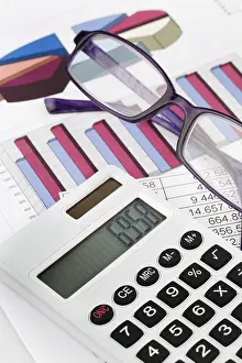 Pocket Calculator Finance Prints: A calculator with graphs of a balance sheet