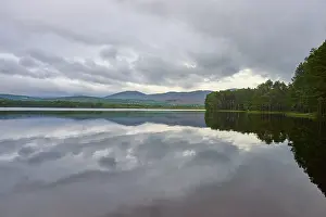 Mountainous Water Reflection Prints: Calm lake with cloud reflection and mountains in the background