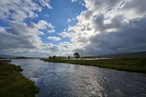 Uninhabited Highland Scenery Prints: A calm river under a partly cloudy