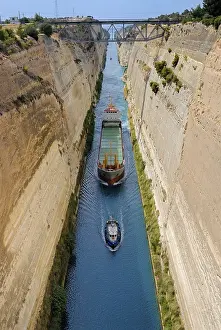 Corinth Canal Prints: Cargo ship being pulled down a canal