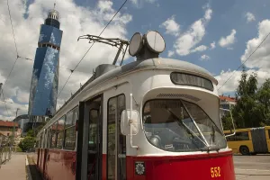 Prints of Sarajevo, Bosnia and Herzegovina July 25th 2019. An old tram waits at a tram stop with the Avaz Twist Tower in the background, Sarajevo, Bosnia and Herzegovina Bosnia And Herzegovina Prints: Sarajevo Tram Stop with Avaz Twist Tower, Print 2019
