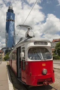 Prints of Sarajevo, Bosnia and Herzegovina July 25th 2019. An old tram waits at a tram stop with the Avaz Twist Tower in the background, Sarajevo, Bosnia and Herzegovina Bosnia And Herzegovina Prints: Sarajevo Tram Stop with Avaz Twist Tower, Print 2019